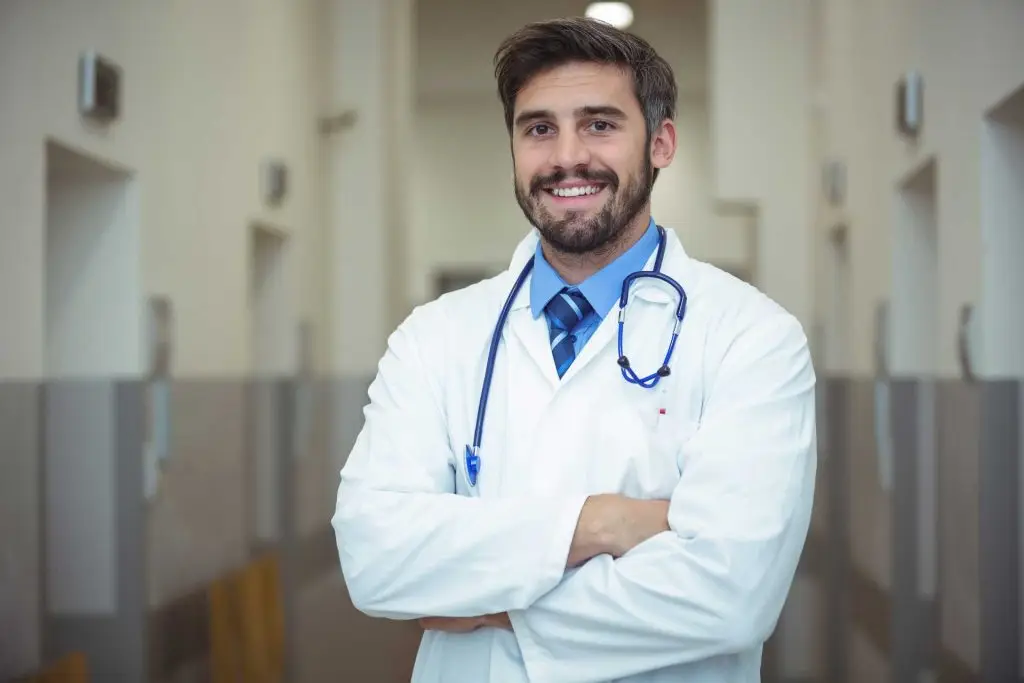 portrait-of-male-doctor-standing-in-corridor-2023-11-27-04-50-27-utc.jpg