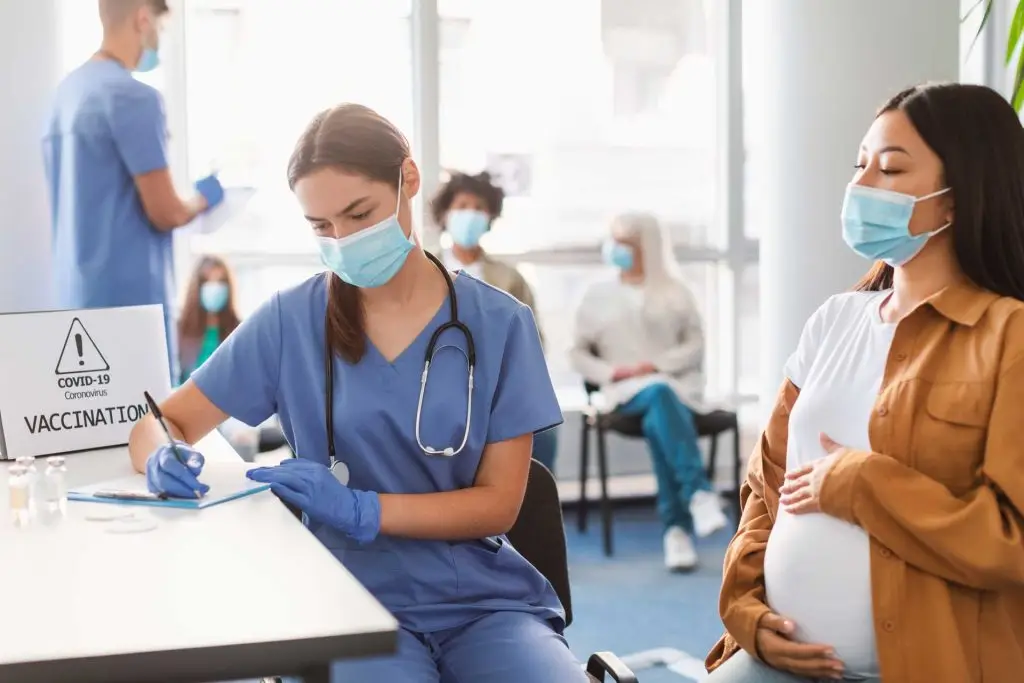 pregnant-lady-in-mask-on-appointment-at-doctor-39-2023-11-27-05-02-33-utc.jpg