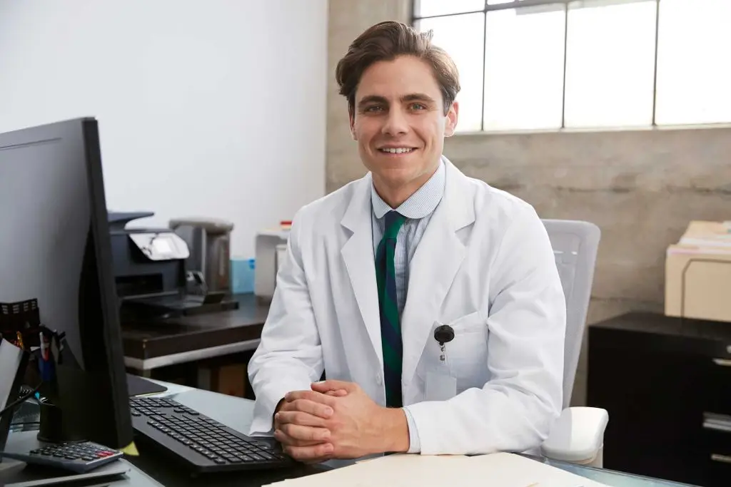 young-white-male-doctor-at-desk-portrait-2023-11-27-05-33-18-utc.jpg